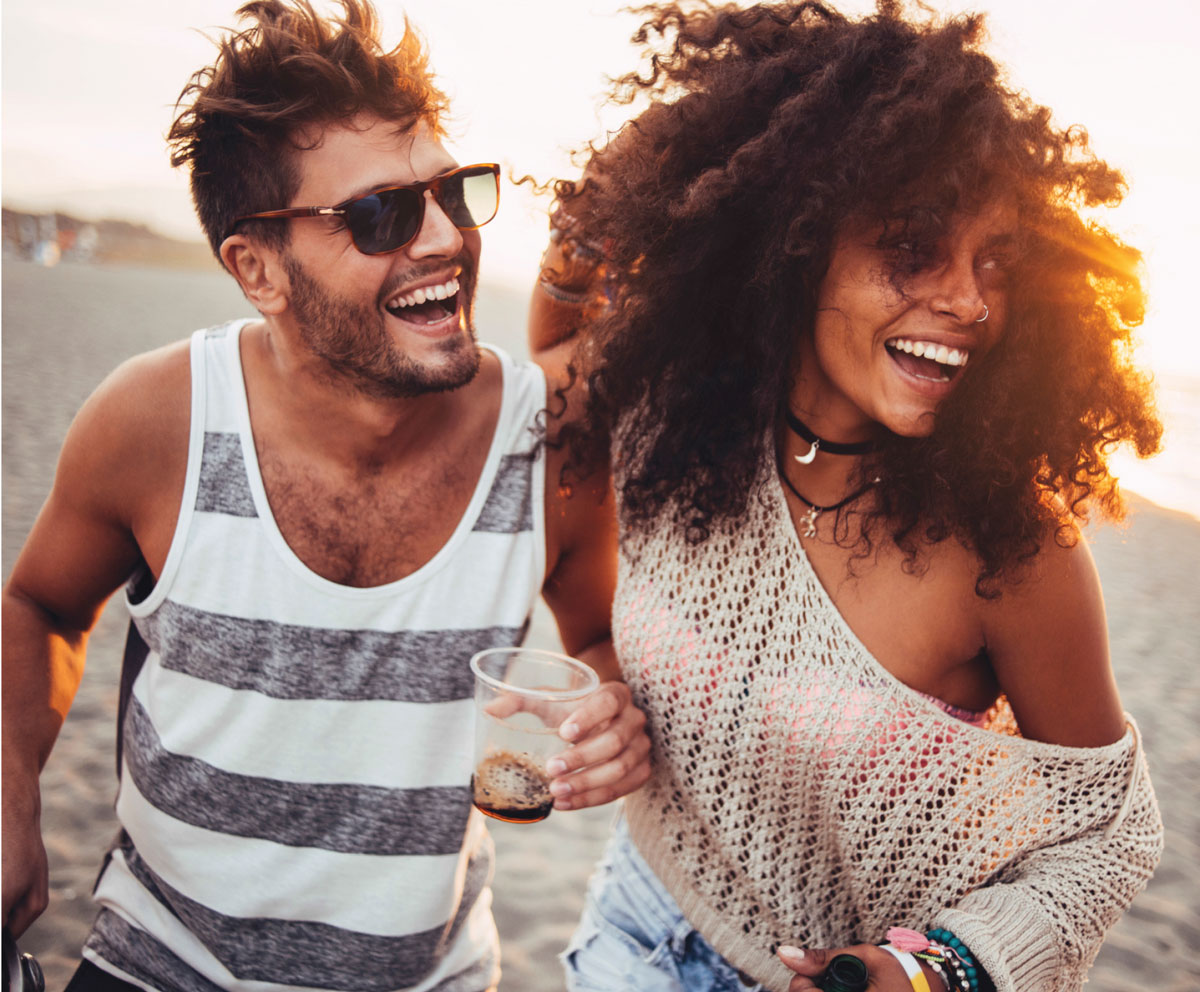Couple enjoying a beach outing made possible by credit card rewards