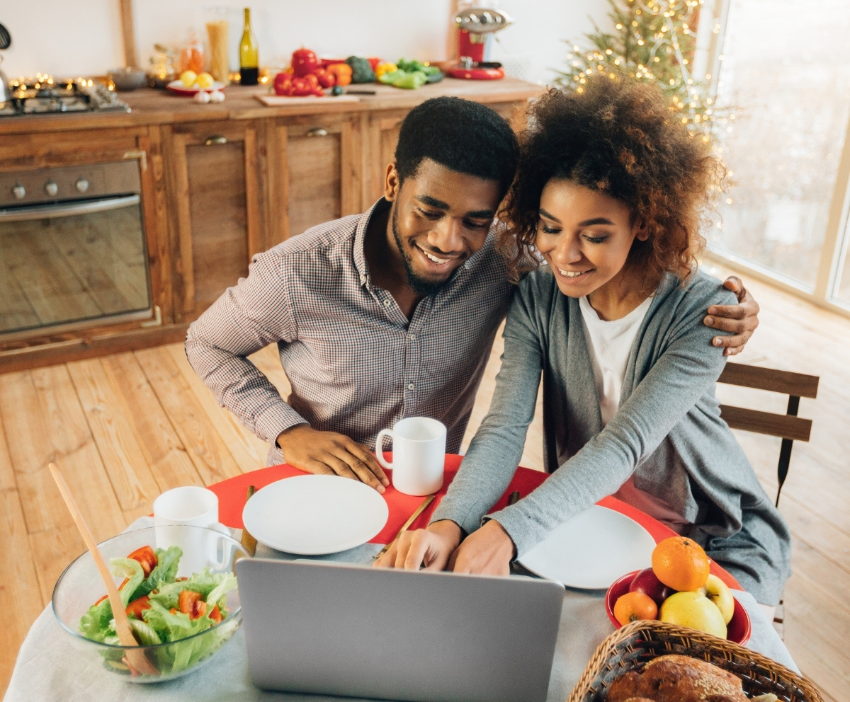 Couple reviewing savings-backed loan options on a laptop