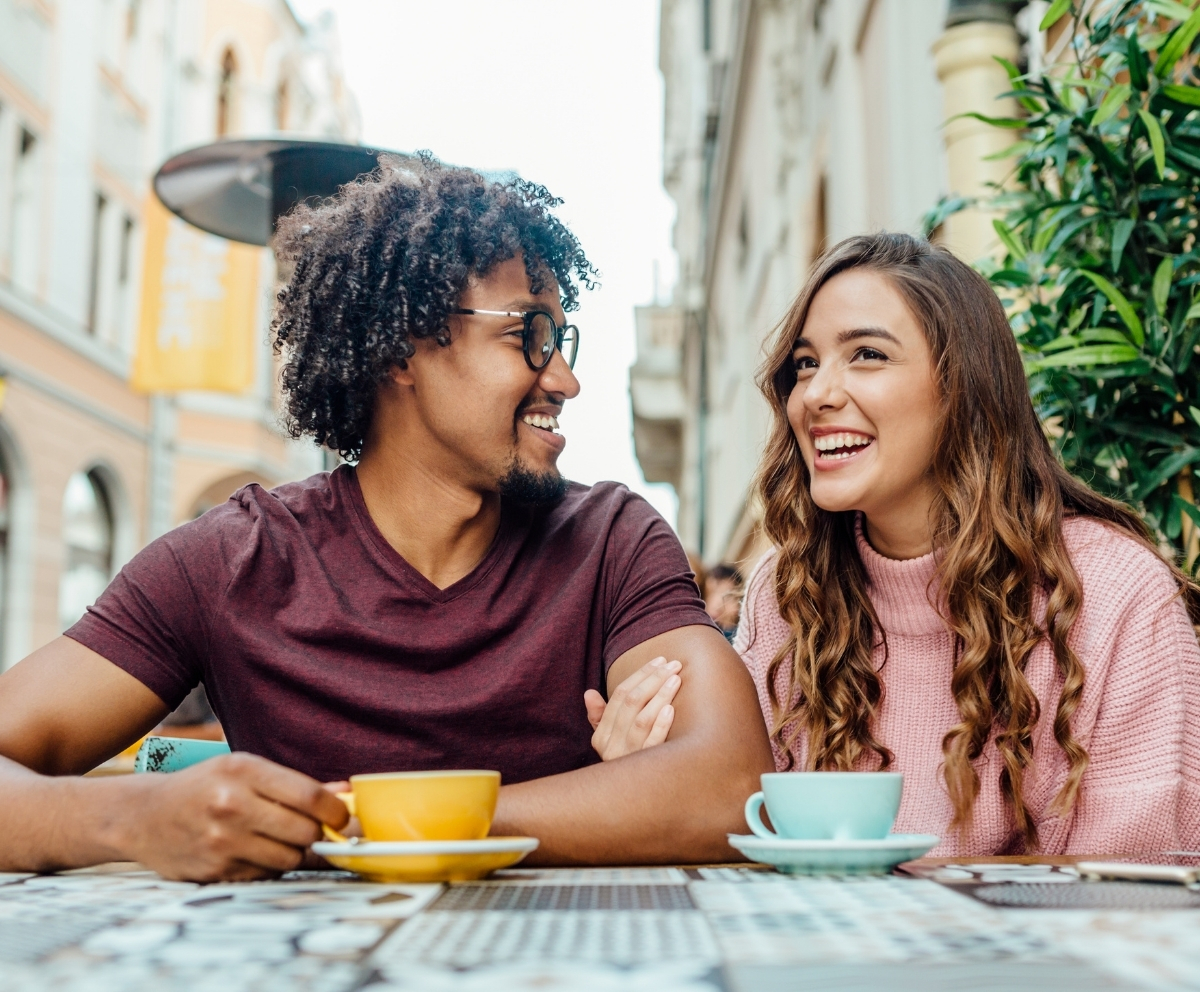 Couple talking over coffee while considering a relationship-based loan option
