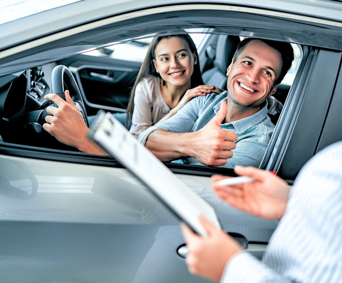 Couple reviewing vehicle protection options at a dealership