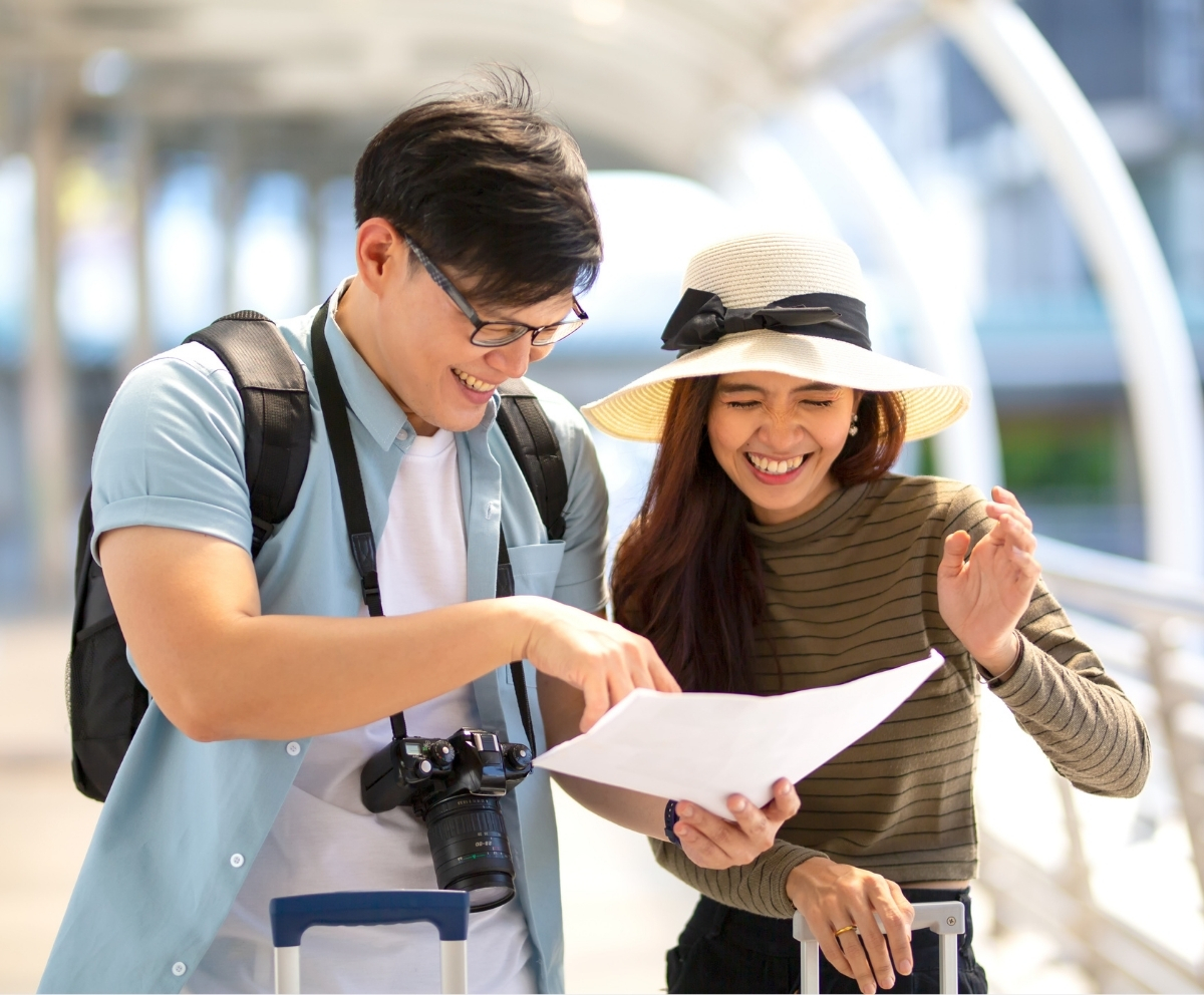 Couple reviewing travel plans while saving for a vacation with a Club Account