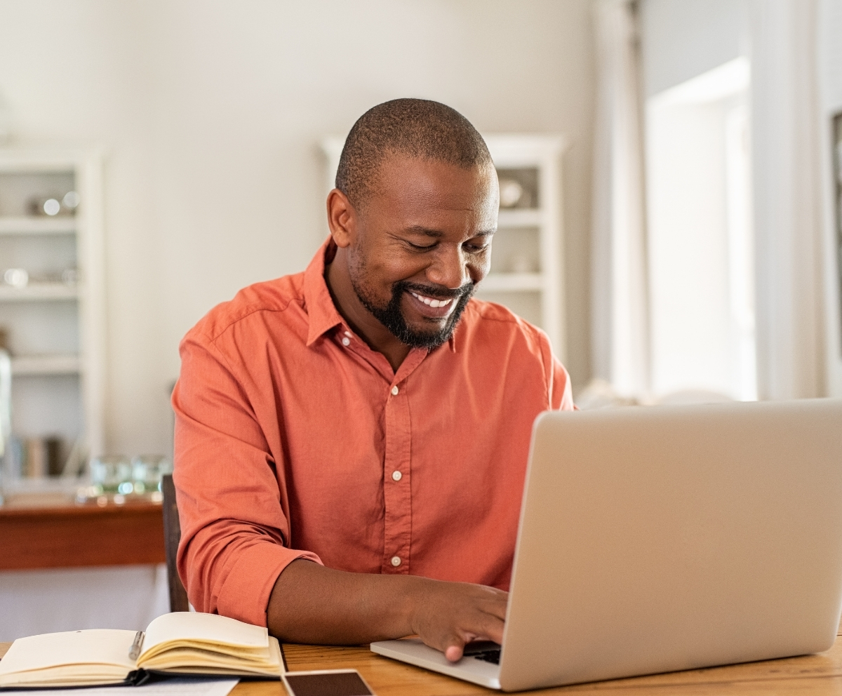 Man reviewing CD rates and savings options on a laptop