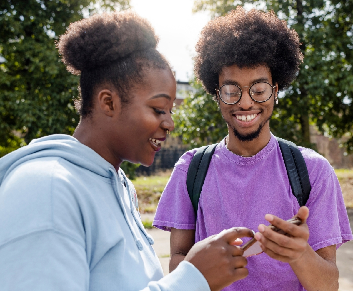 Young adults reviewing retirement savings information on a smartphone