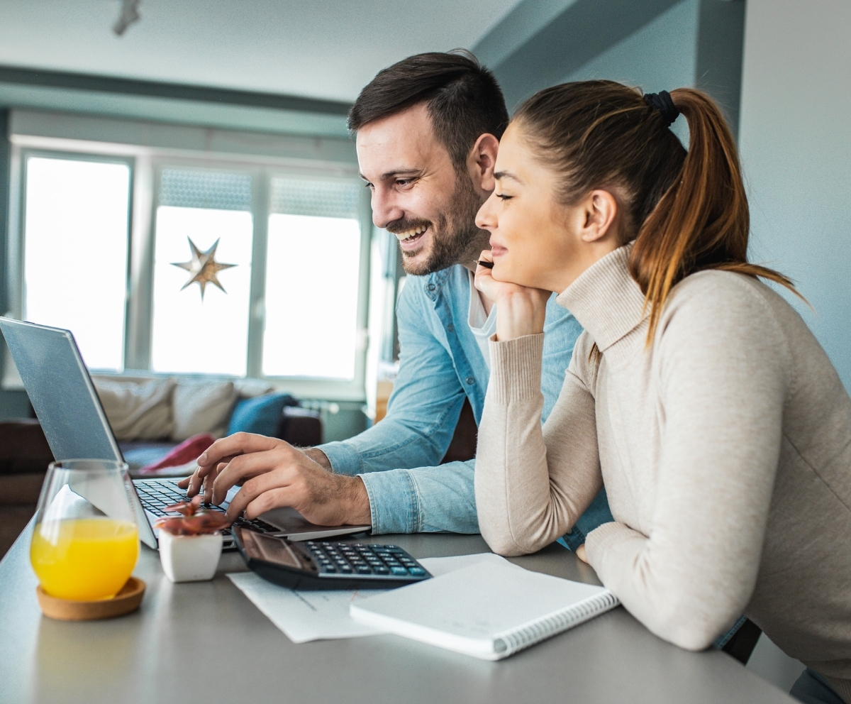 Couple reviewing mortgage options and home loan details on a laptop