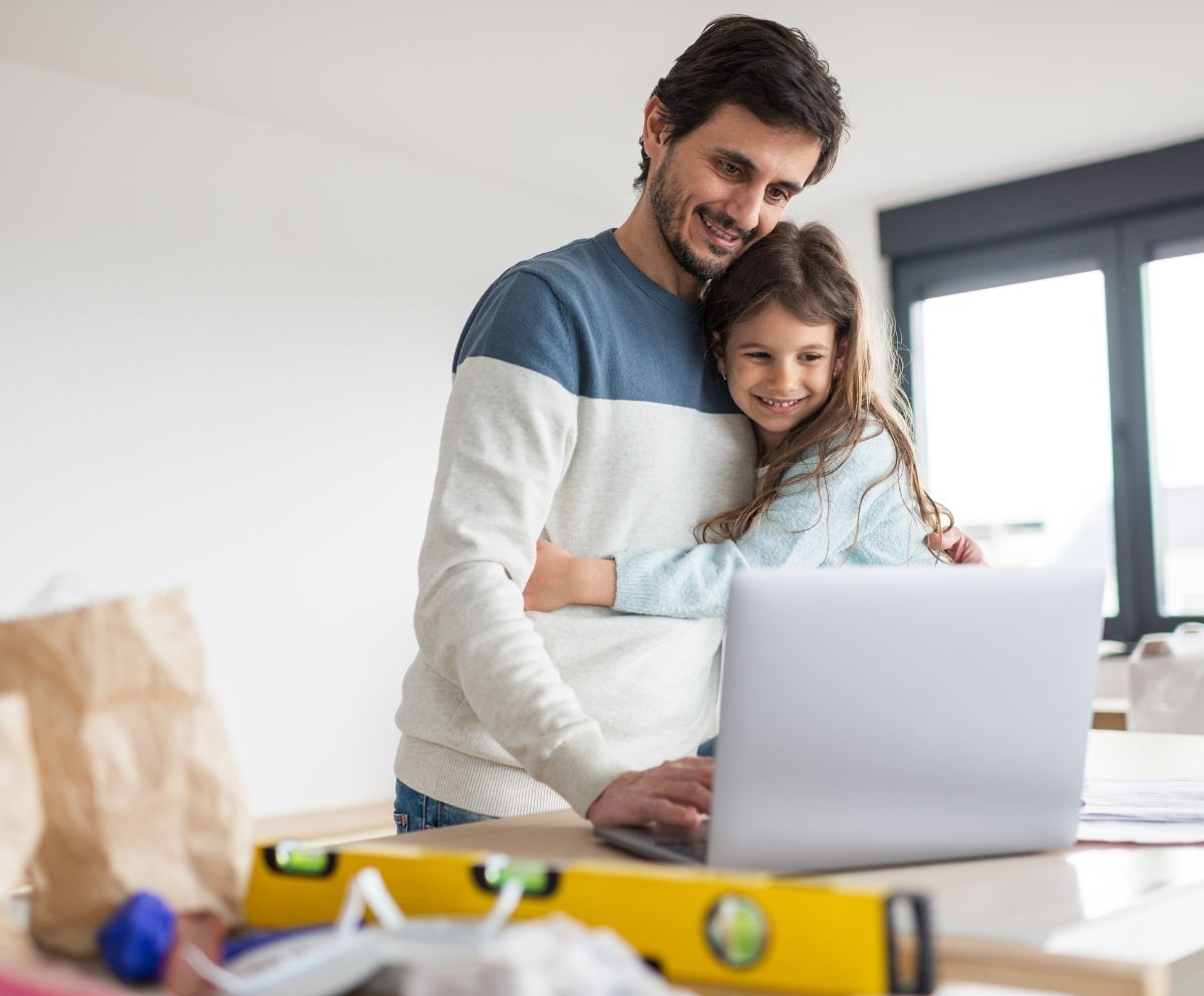 Parent using a laptop to review HELOC options for home improvements