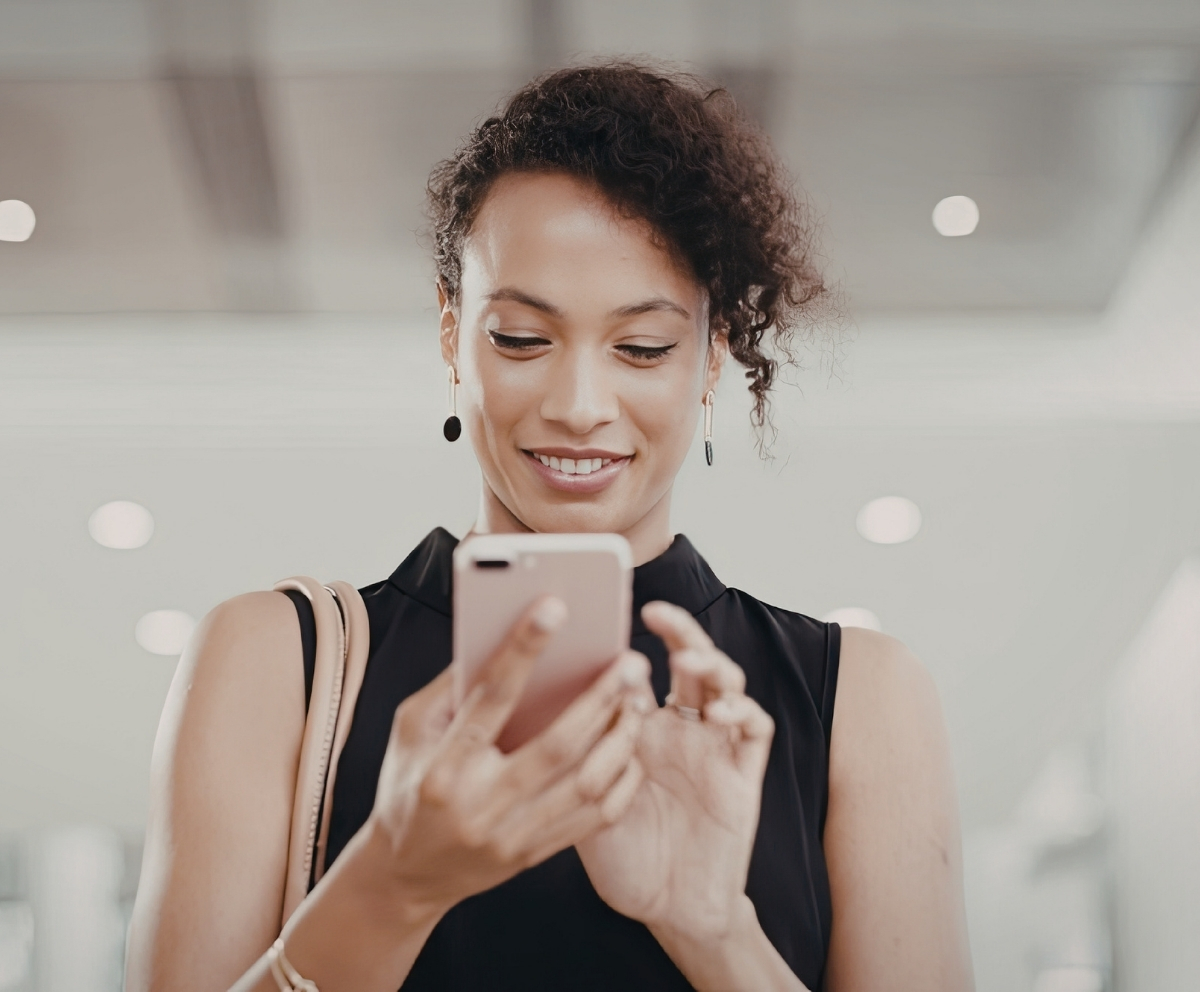 Woman using a smartphone to access Mobile Banking from Connect Credit Union