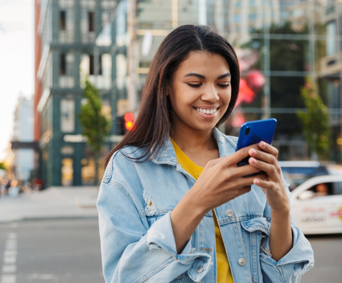 Woman using Mobile Banking on a smartphone while on the go