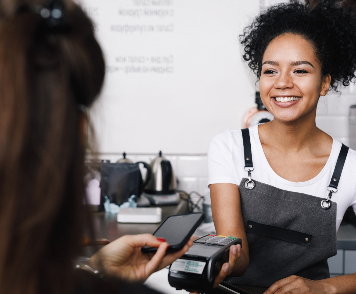 Customer making a secure Mobile Wallet payment at a contactless card terminal