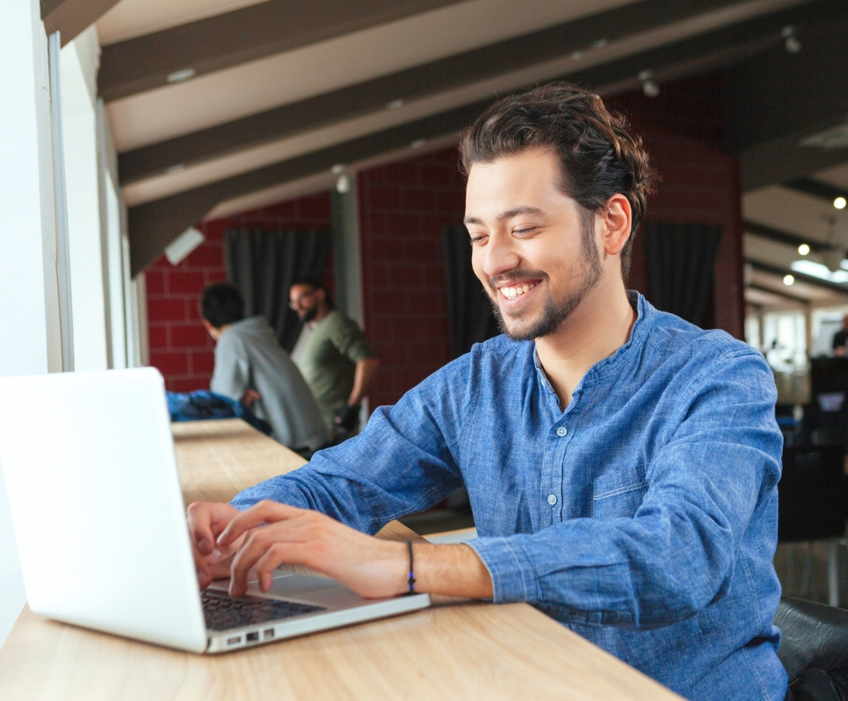 Man using a laptop to manage accounts through Connect Credit Union Online Banking