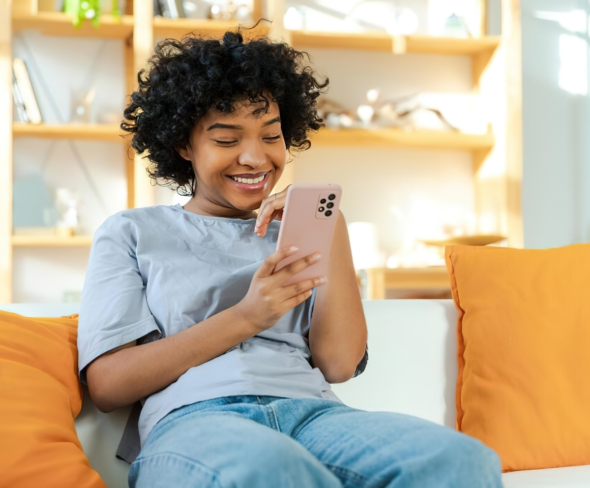 Woman using mobile access to manage Connect Credit Union accounts from home