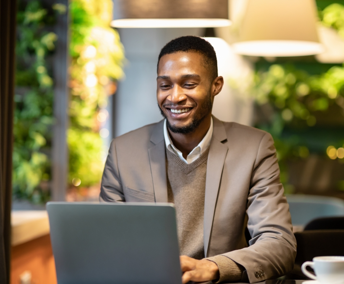 Man using Online Banking on a laptop while away from home