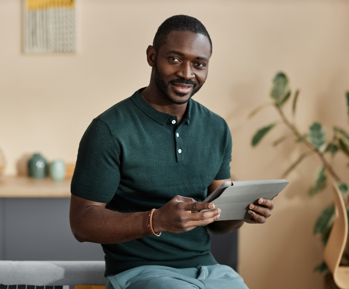 Man using a tablet to review debt consolidation loan options