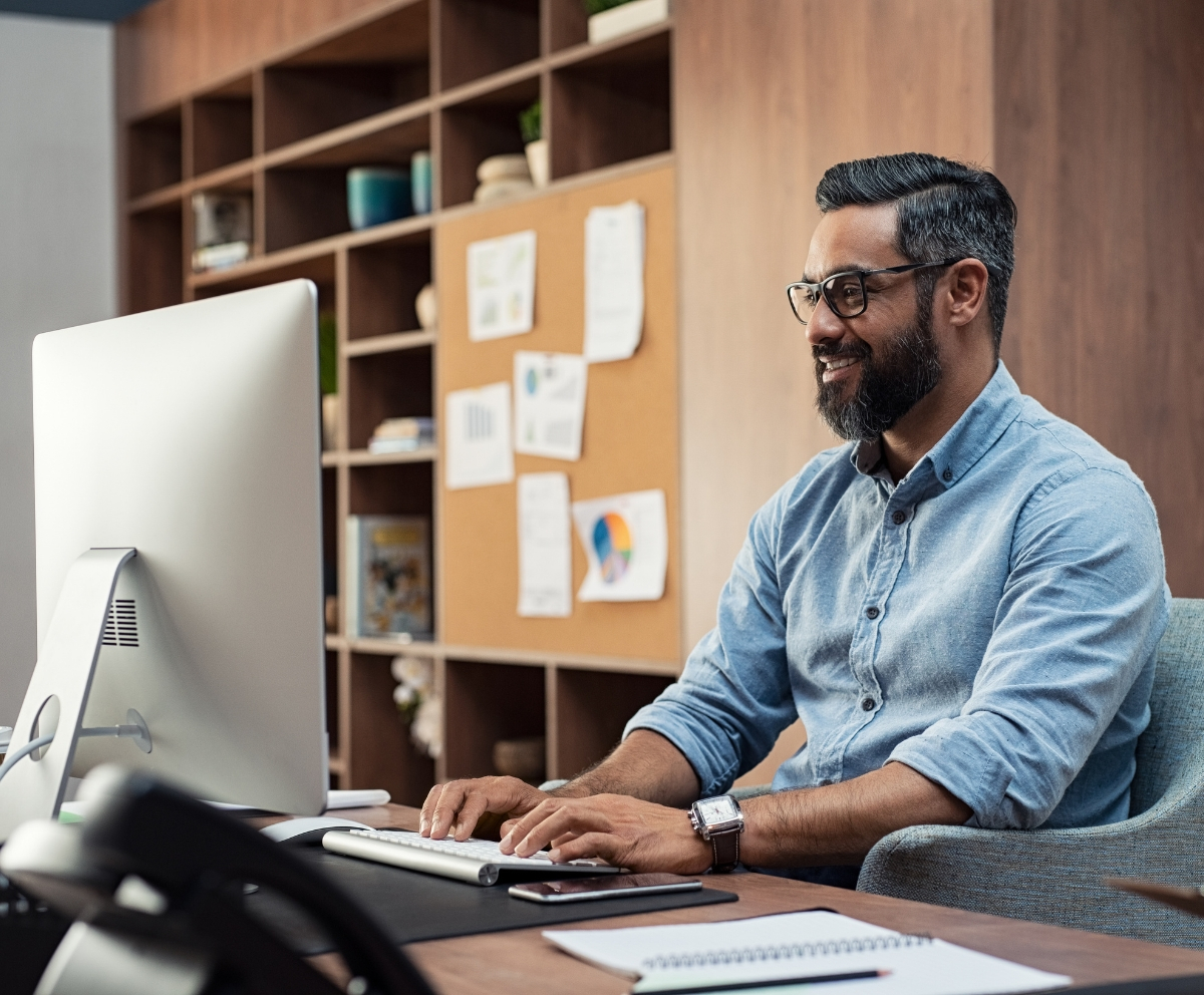 Man using computer to pay bills with online banking