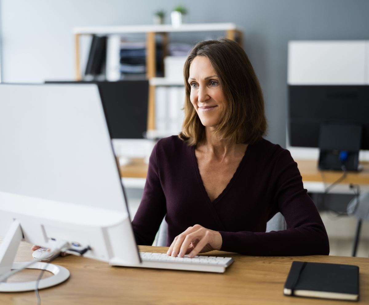 Woman using computer at home using bill pay online